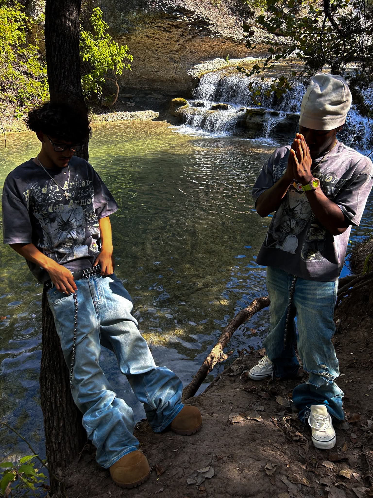Two models wearing the Hidden Armory tee at the creek